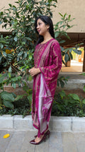 Side view of magenta art silk kurta showing yoke embroidery and matching pants
