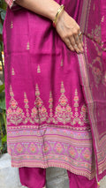 Detail of embroidered yoke and floral motifs on magenta art silk