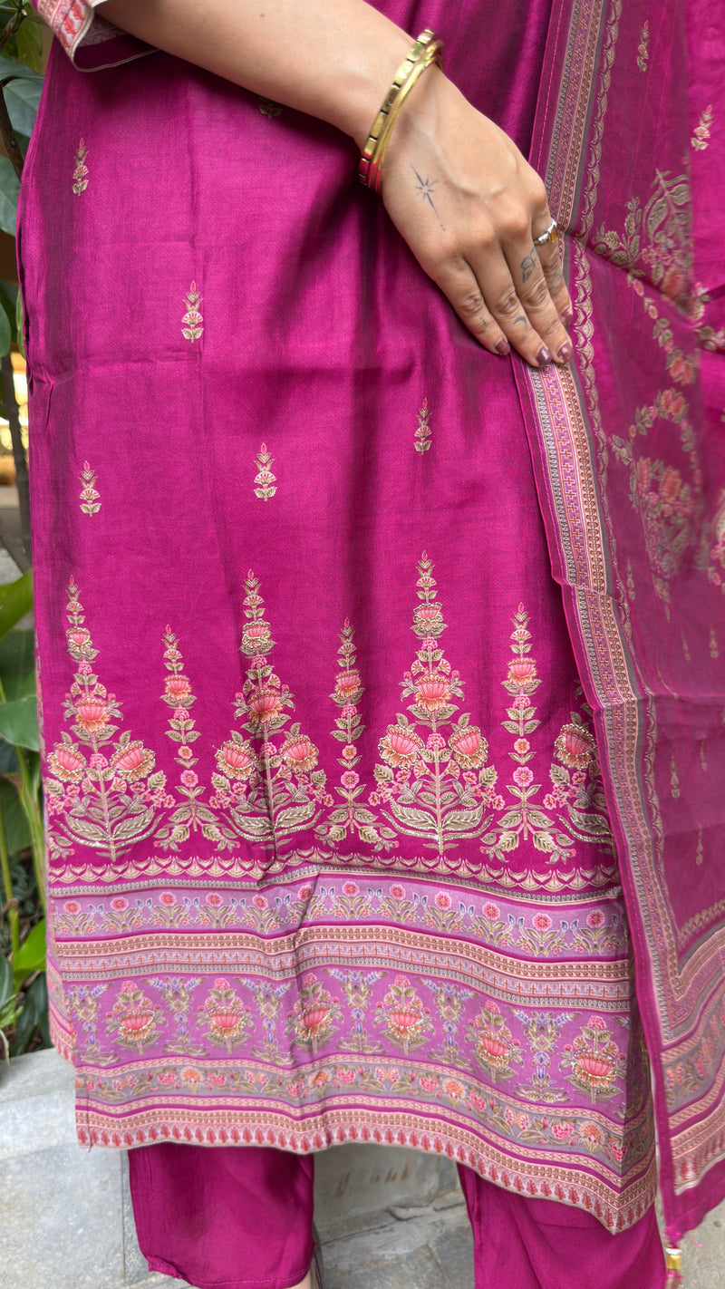 Detail of embroidered yoke and floral motifs on magenta art silk