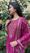 Three-quarter view of magenta kurta showing embroidered hem