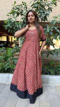Detail of small white floral buti motifs on red handloom cotton