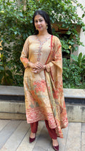 Side view of beige simmer tissue kurta with floral printed dupatta