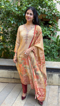 Full-length view of beige kurta set with coral floral dupatta
