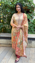 Detail of red embroidered neckline on beige simmer tissue kurta