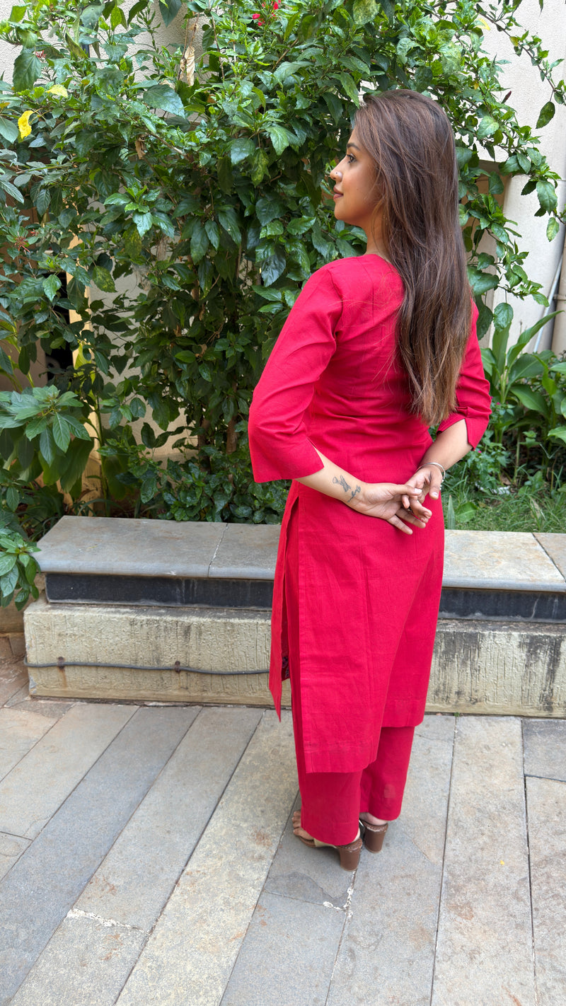 Front view of plain red kurta showing clean lines and three-quarter sleeves