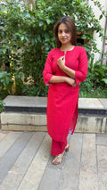 Close-up of red kurta neckline and sleeve cuff