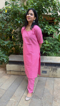 Model in solid pink handloom cotton kurta set with scoop neckline and elbow sleeves