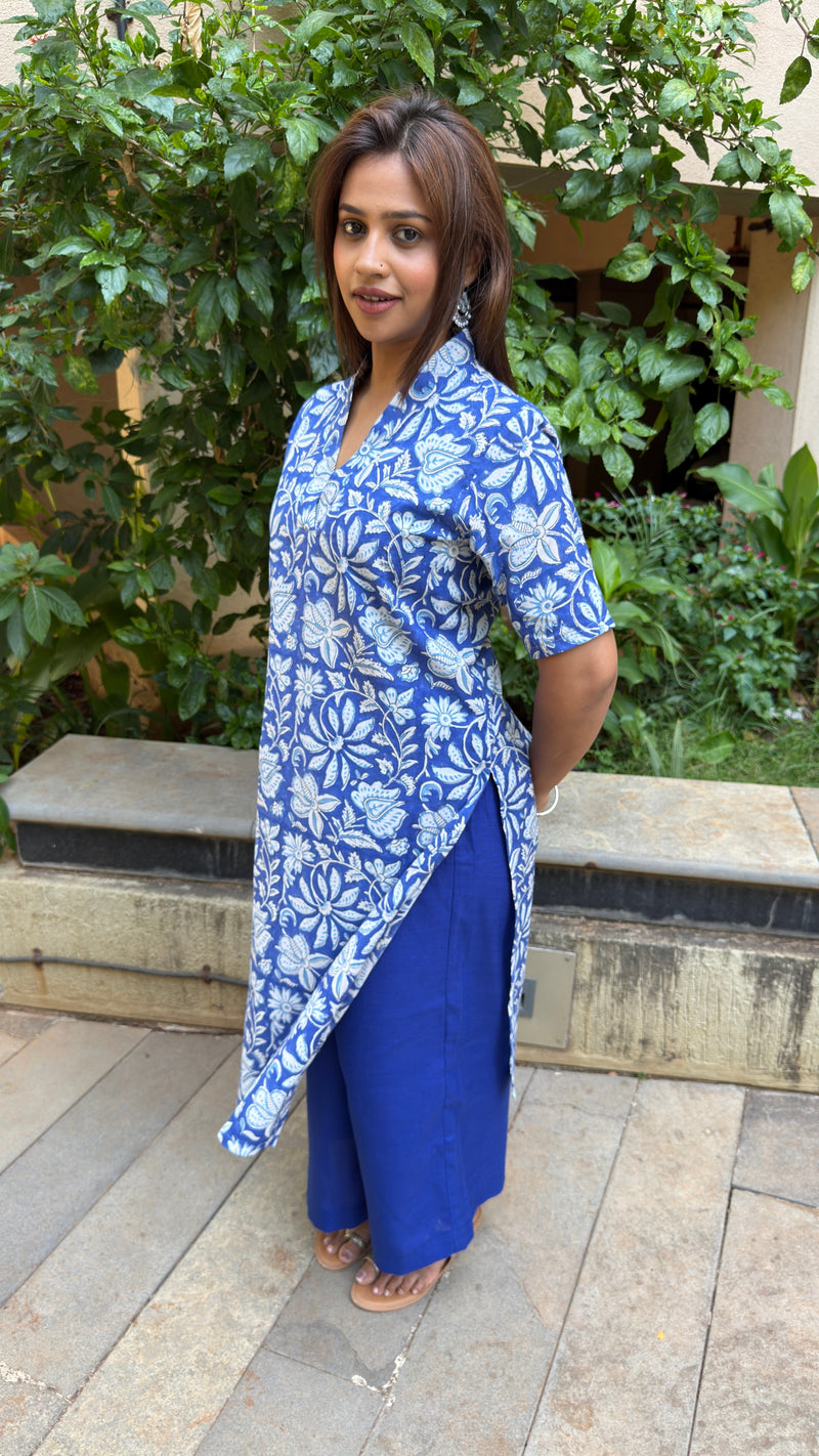 Full height shot focusing on the straight leg blue pants paired with the printed cotton kurta outdoors