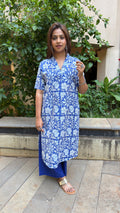 Model in blue printed kurta walking through outdoor space