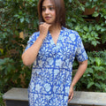 Full body view of a woman modelling the blue printed cotton kurta set with sandals on stone flooring