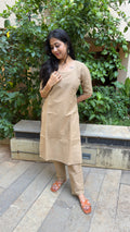 Front view of plain beige kurta showing clean silhouette and elbow sleeves