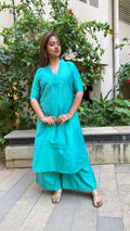 Model in teal kurta with palazzo in natural light