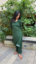 Three-quarter view of dark green kurta set