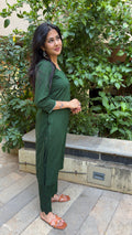 Model in dark green kurta walking outdoors