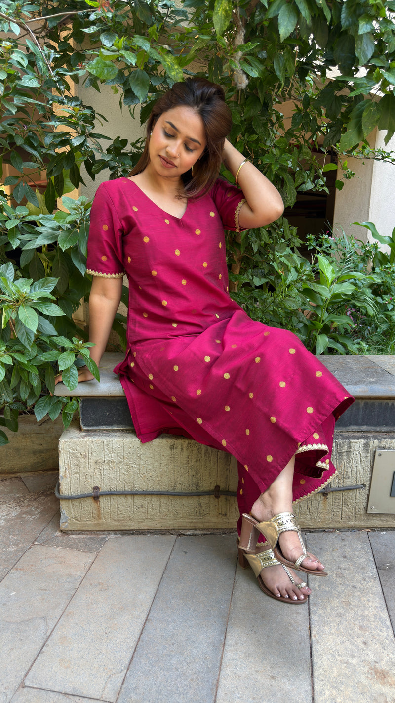 Front view of magenta kurta showing scattered gold motifs