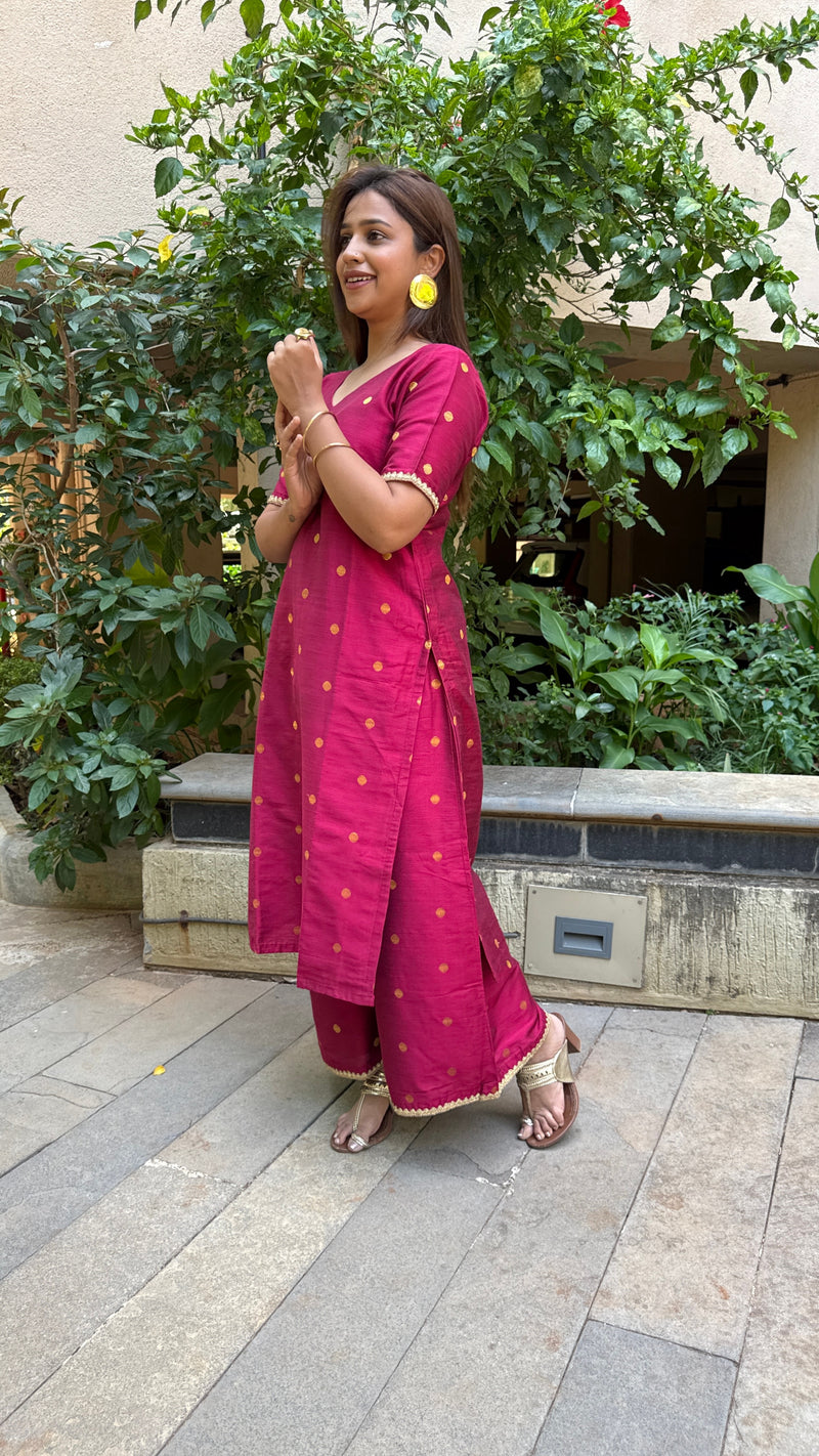 Side view of magenta kurta with elbow sleeves and matching pants