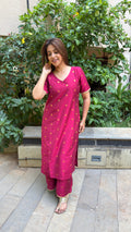Detail of small gold buti motifs on magenta slub silk