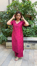 Model in magenta kurta walking through outdoor space