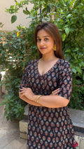Close-up of V-wrap closure on black hand block printed cotton dress