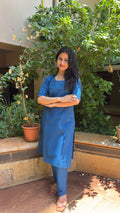 Model in steel blue kurta walking outdoors