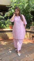 Side view of light pink kurta showing relaxed fit and matching pants