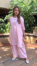 Model in light pink kurta walking outdoors