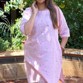 Upper torso view of the light pink cotton kurta with hands resting near the pocket area.