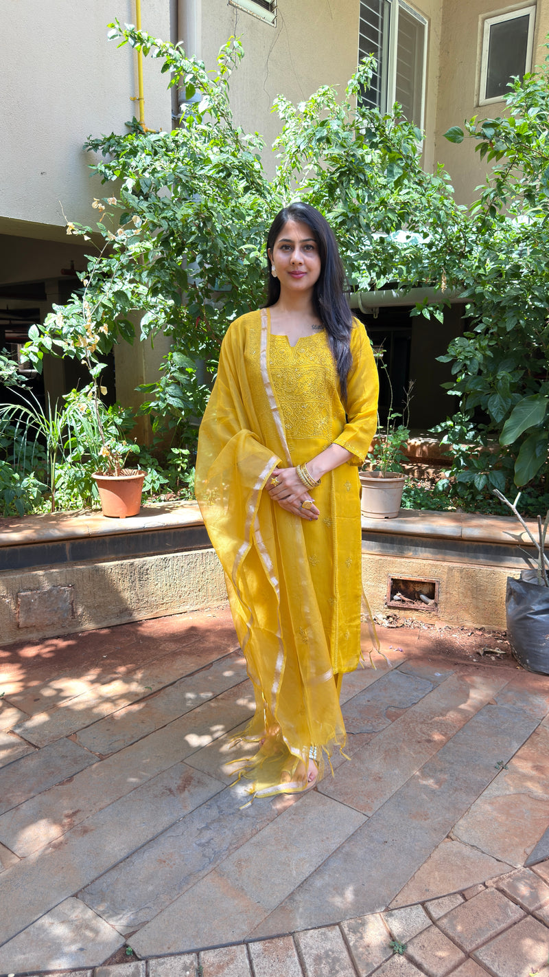 Front view of yellow chikankari kurta with embroidered yoke and dupatta drape