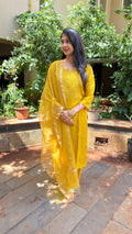 Full-length view of yellow organza kurta set with matching dupatta