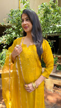 Close-up of yellow organza fabric with delicate chikankari stitching