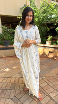 Full-length view of ivory kurta set with grey embroidery, in natural light
