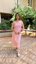 Full-length view of pink floral cotton dress in soft daylight