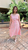 Detail of small floral block print motifs on soft pink handloom cotton