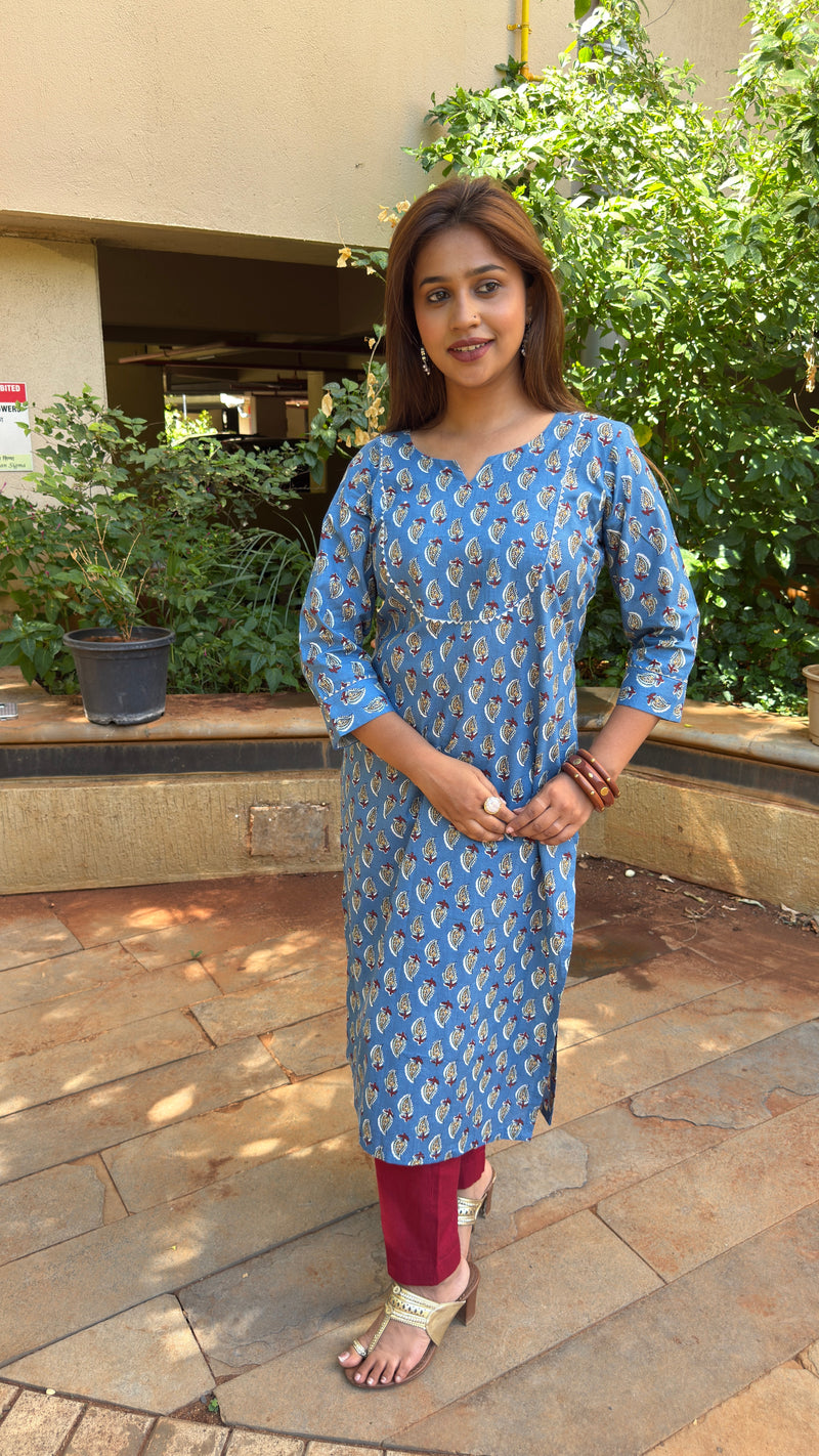 Three-quarter view of blue paisley kurta with maroon pants