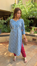 Model in blue paisley kurta walking through outdoor space