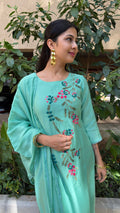 Full-length view of mint embroidered kurta set in natural light