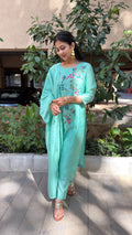 Model in mint kurta walking through outdoor setting