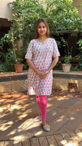 Three-quarter view of white floral block print kurta set