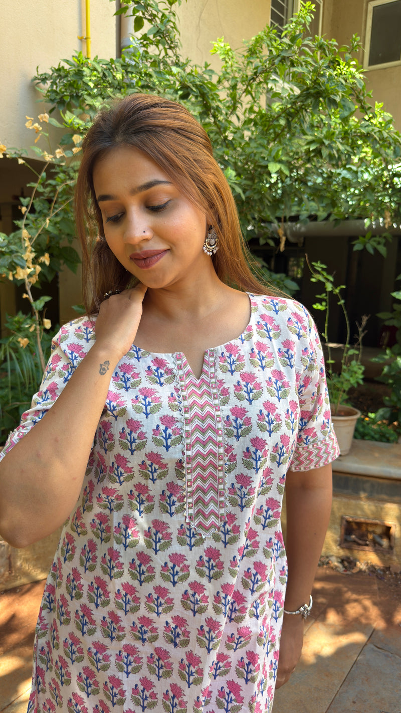 Side view of white printed kurta with pink pants