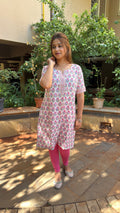Model in white block print kurta walking outdoors