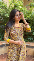 Side view of olive long dress showing mustard yellow trim at neckline and hem