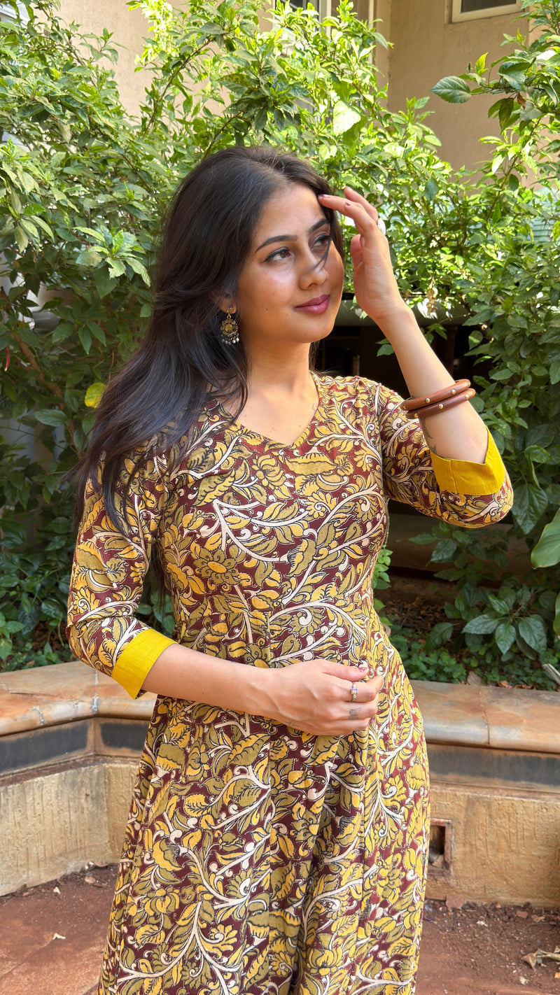 Side view of olive long dress showing mustard yellow trim at neckline and hem
