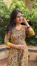Detail of mustard yellow floral block print on olive handloom cotton