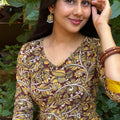 Portrait of a woman wearing the olive yellow cotton long dress with traditional wooden bangles.