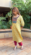Side view of yellow kurta showing Ajrakh yoke detail and side slit