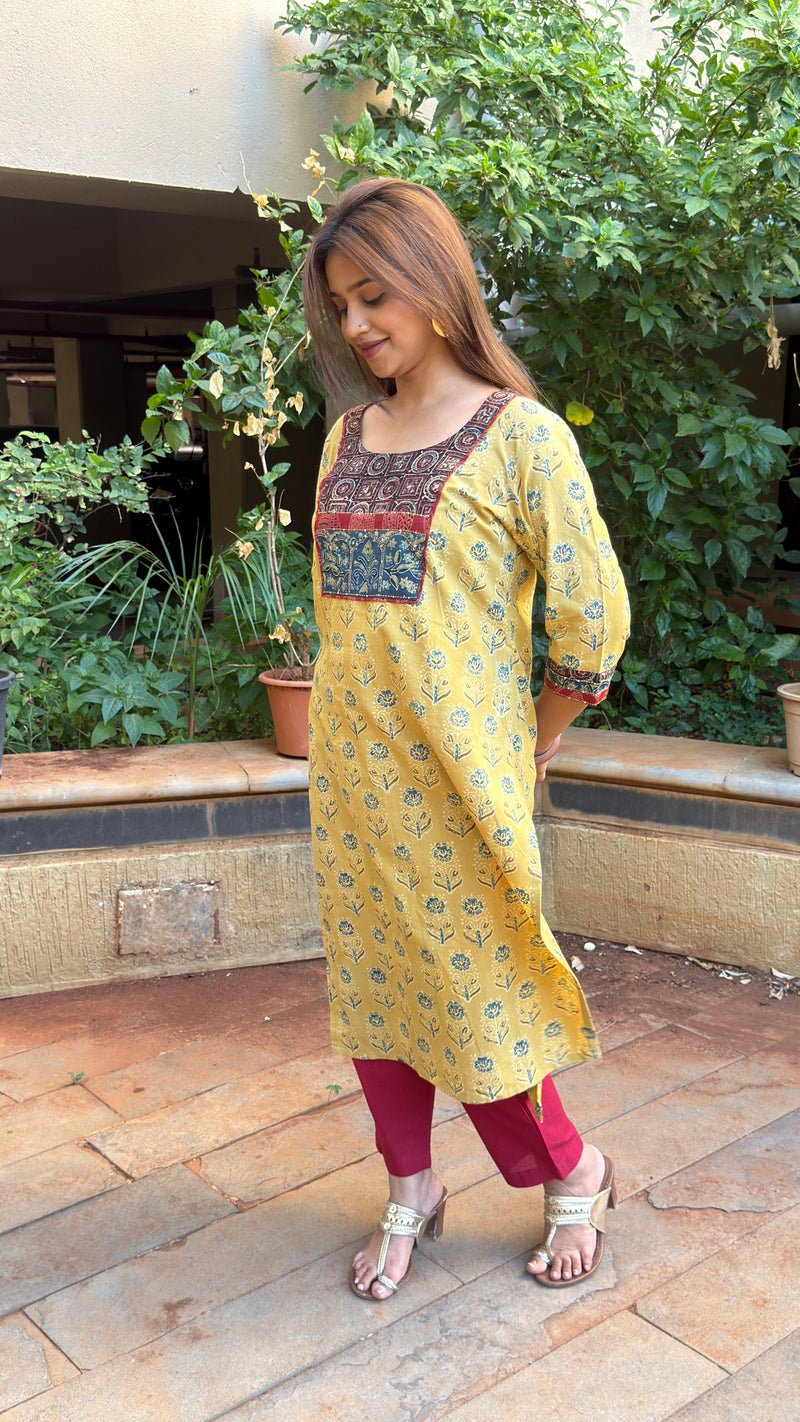 Side view of yellow kurta showing Ajrakh yoke detail and side slit