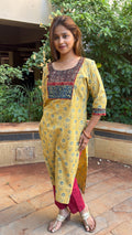 Close-up of contrast maroon Ajrakh yoke on yellow kurta