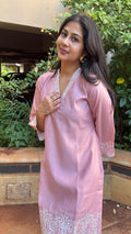 Front view of pink kurta showing cutwork hem and V-neckline trim