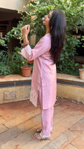Side view of pink kurta showing relaxed silhouette and pants
