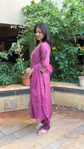 Detail of gold embroidered motifs on mauve cotton-silk